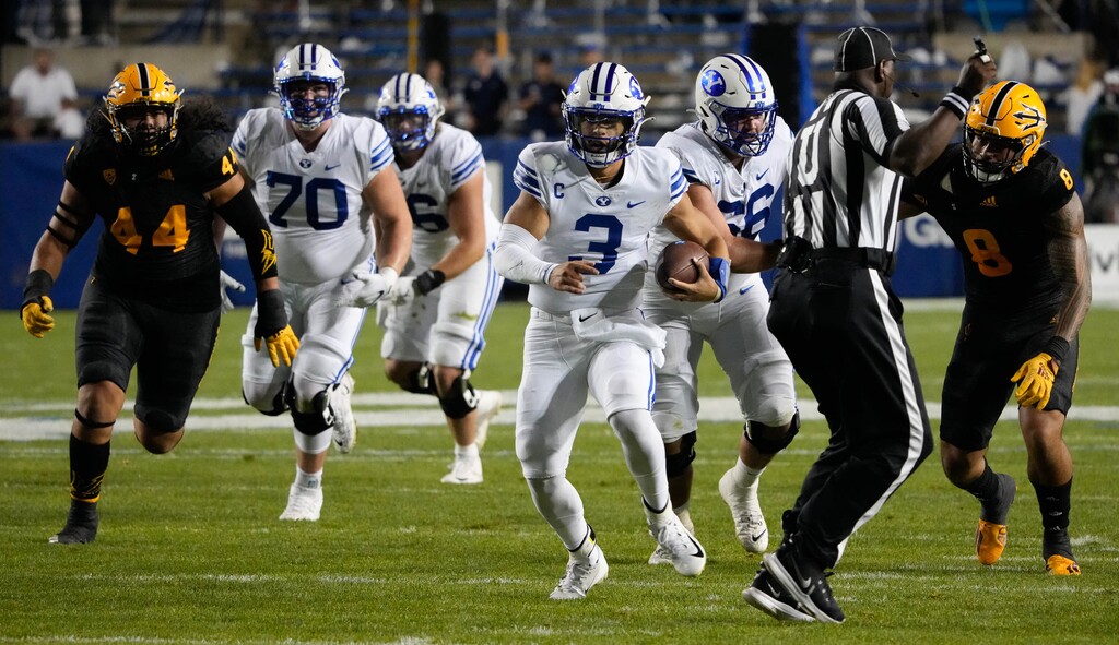 (Francisco Kjolseth | The Salt Lake Tribune) Brigham Young Cougars quarterback Jaren Hall (3) runs the ball as a referee tries to stay out of the way in football action between the Brigham Young Cougars and the Arizona State Sun Devils at LaVell Edwards Stadium in Provo, on Saturday, Sept. 18, 2021.