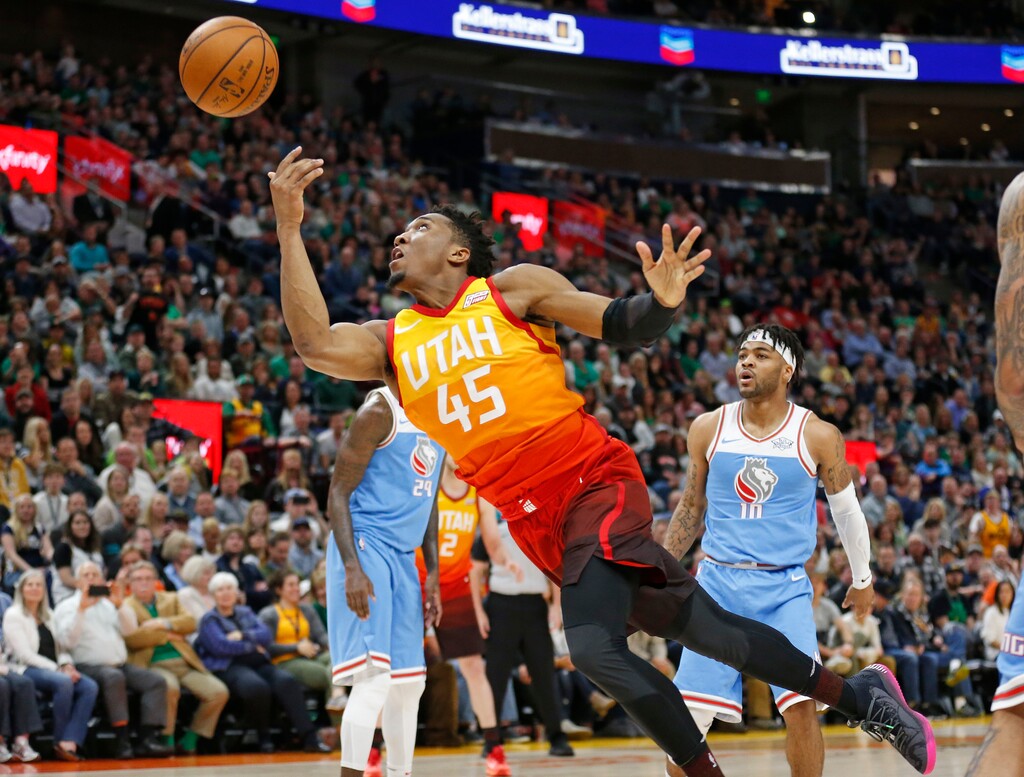 (Rick Bowmer | The Associated Press) Utah Jazz guard Donovan Mitchell (45) lays the ball up as Sacramento Kings guard Frank Mason III, right, watches during the second half of an NBA basketball game Saturday, March 17, 2018, in Salt Lake City.