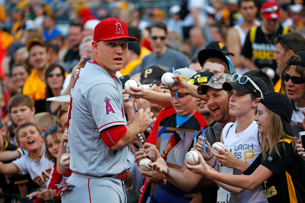(AP Photo/Gene J. Puskar) Los Angeles Angels' Mike Trout, left, signs autographs for fans before a baseball game against the Pittsburgh Pirates at PNC Park in Pittsburgh, Friday, June 3, 2016.