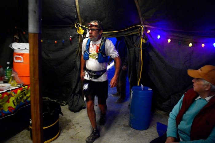 (Scott Sommerdorf | The Salt Lake Tribune)
Seventh place finisher Todd Vogel enters and passes through Aid Station 14 - the last checkpoint before the finish line - at the Salt Flats 100 Endurance Run, Saturday, May 5, 2018.
