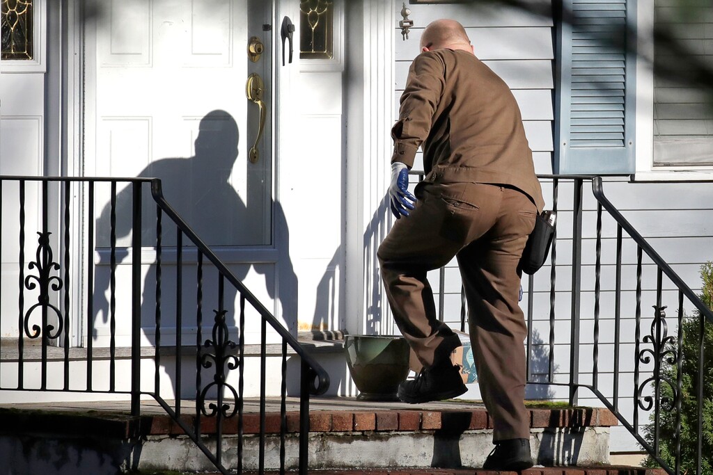 (Elise Amendola | AP file photo) A UPS man delivers an Amazon package to a residence in North Andover, Mass., on Nov. 26, 2019. Amazon, Walmart and others are promising to deliver more of their goods in a day and this holiday season will be the first real test of whether they can make that happen.