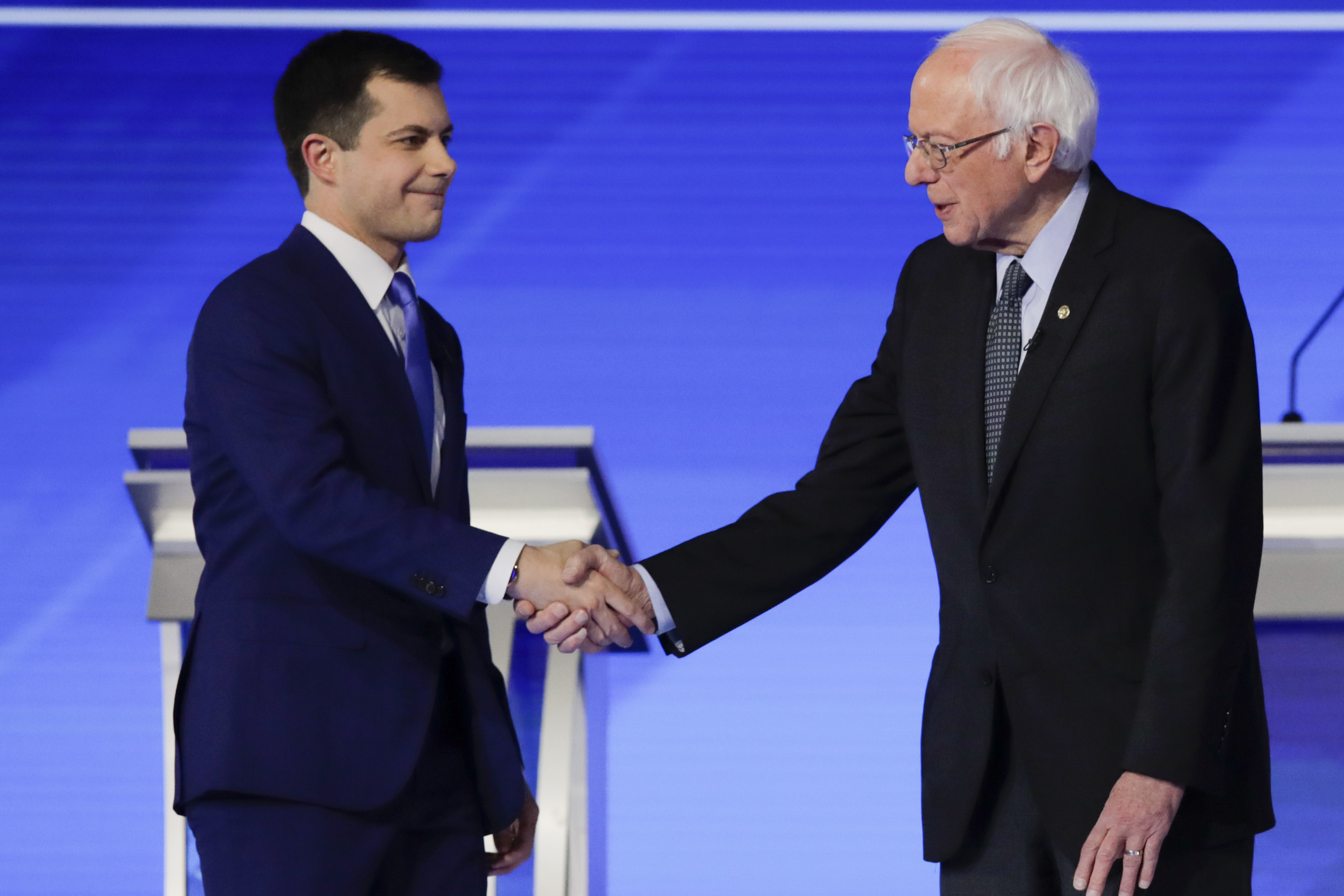 (Charles Krupa | AP) Democratic presidential candidates former South Bend Mayor Pete Buttigieg and Sen. Bernie Sanders, I-Vt., shake hands on stage Friday, Feb. 7, 2020, before the start of a Democratic presidential primary debate hosted by ABC News, Apple News, and WMUR-TV at Saint Anselm College in Manchester, N.H.