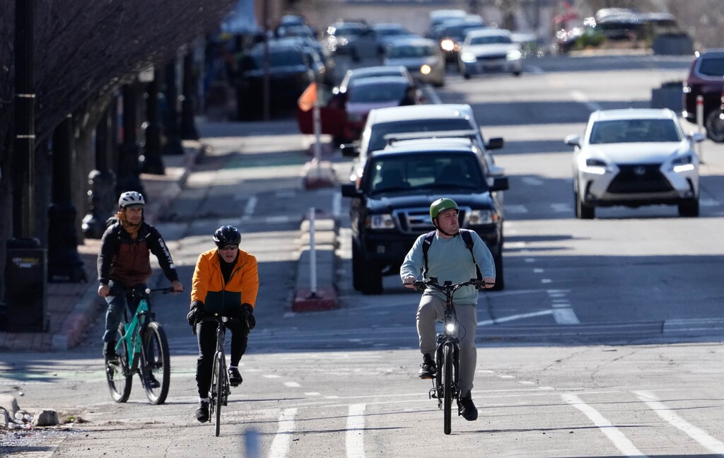 (Francisco Kjolseth | The Salt Lake Tribune) Cyclists use the designated bike lanes along 300 South in downtown Salt Lake City on Thursday, March 16, 2023. 