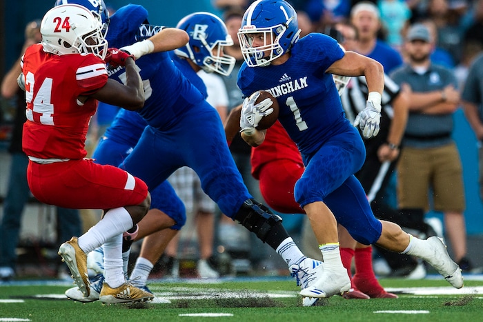 (Chris Detrick  |  The Salt Lake Tribune)  Bingham's Braedon Wissler (1) runs past East's Jaylon Vickers (24) during the game at Bingham High School Friday, August 25, 2017. Bingham is winning the game 24-17 at halftime. 