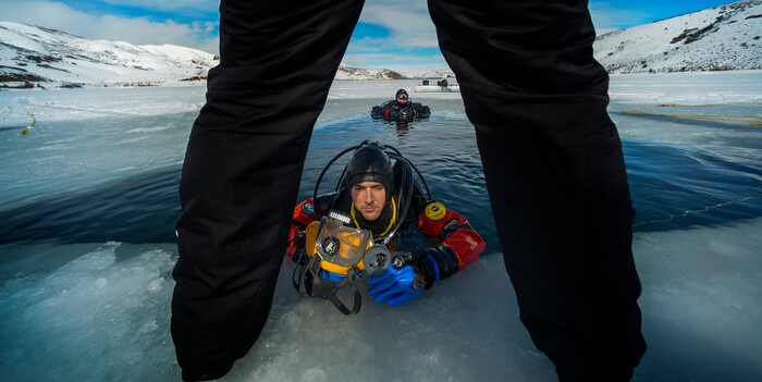 Leah Hogsten | The Salt Lake Tribune Riverside County Sheriff's Department dive member Devon Schmidt exits the water during training Wednesday to tend to repair his mask with the help of team member Jerry Osterloh. The Utah Department of Public Safety's Dive Team and the Riverside County Sheriff's Office joined forces for a day of ice diving at Deer Creek Reservoir, Feb. 20, 2019. Twenty members from Riverside County Sheriff's Department dove in icy waters alongside DPS' 10 man team in a joint team training day, Wednesday. Members of the Riverside County Sheriff's were working to become certified in ice diving under the team's lieutenant and dive master. Due to the equipment assets and the unique diver skill sets, dive teams are often called upon to provide assistance to aquatic homicide investigations and accidental drownings.