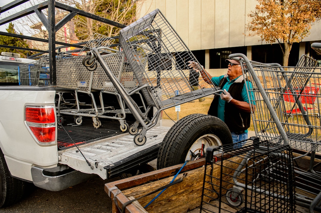(Trent Nelson  |  The Salt Lake Tribune) Antonio Hernandez loads a shopping cart reclaimed near the Salt Lake City Library on Tuesday, Nov. 19, 2019. Hernandez, an employee of Romac, is assigned to drive around the city and pick up stolen or abandoned shopping carts for return to stores.