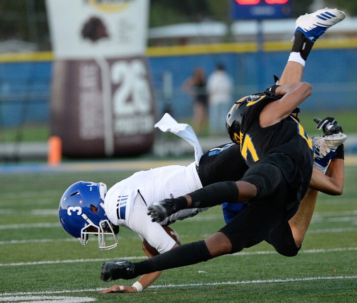 (Francisco Kjolseth  |  The Salt Lake Tribune)  Bingham's Peyton Jones is upended by Orem's Jakob Robinson during the first half of the game in Orem, Thursday, Aug. 16, 2018.