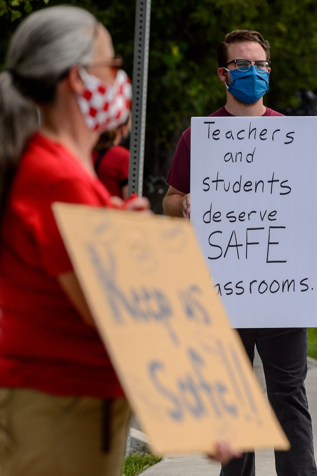 (Trent Nelson  |  The Salt Lake Tribune) Kevin Engberson, a teacher at Copper Mountain Middle School, joined other teachers and parents holding signs calling for a safe plan on reopening schools prior to a Jordan School District board meeting in Riverton on Tuesday, July 28, 2020.