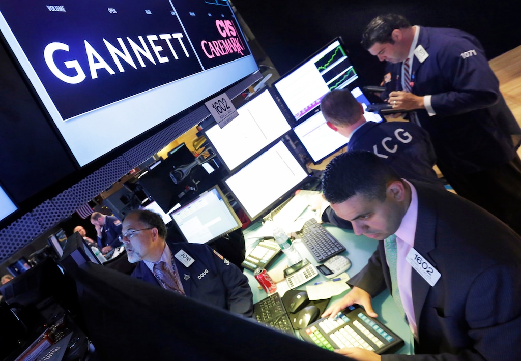 (Richard Drew | AP file photo) In this Aug. 5, 2014, file photo, specialist Michael Cacace, foreground right, works at the post that handles Gannett on the floor of the New York Stock Exchange. Gannett, publisher of USA Today, said Monday, Feb. 4, 2019, that its board has unanimously rejected a $1.36 billion buyout offer from a media group with a history of taking over struggling newspapers and slashing jobs.