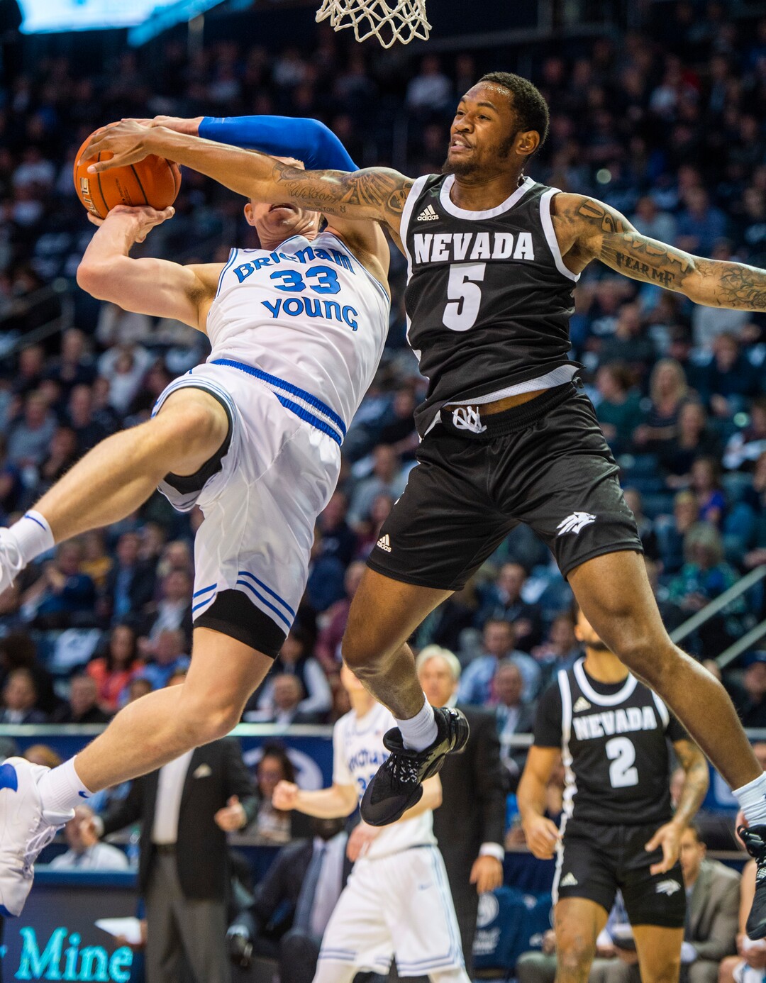 (Rick Egan  |  The Salt Lake Tribune)       Nevada Wolf Pack guard Nisre Zouzoua (5) stops a layup by Brigham Young Cougars forward Dalton Nixon (33), in basketball action between the Brigham Young Cougars and the Nevada Wolf Pack, at the Marriott Center, in Provo, Saturday, December 10, 2019.