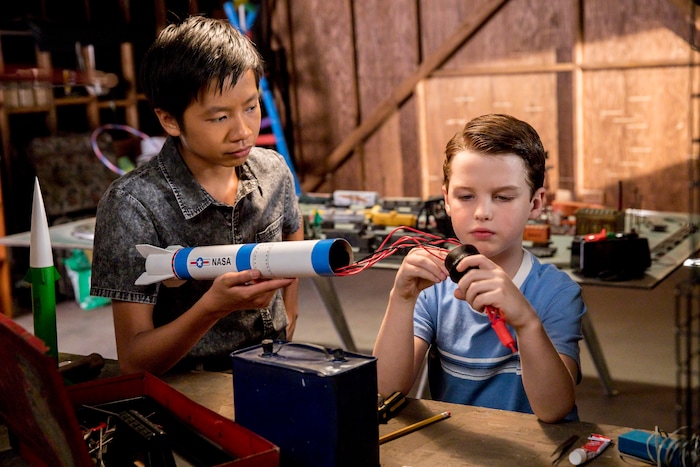 (Photo: Robert Voets/Warner Bros.) Tam (Ryan Phuong) and Sheldon (Iain Armitage) work on a model rocket on “Young Sheldon.”