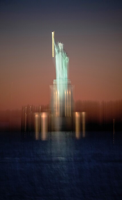 (Damon Winter | The New York Times)

A blurred image at dusk of the Statue of Liberty in New York, Nov. 6, 2020.