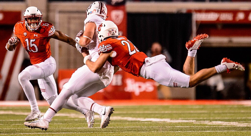(Trent Nelson | The Salt Lake Tribune)  Utah Utes defensive back Chase Hansen (22) dives at Stanford Cardinal tight end Dalton Schultz (9) as the University of Utah hosts Stanford, NCAA football at Rice-Eccles Stadium in Salt Lake City Saturday October 7, 2017. At left is Utah Utes defensive back Corrion Ballard (15).