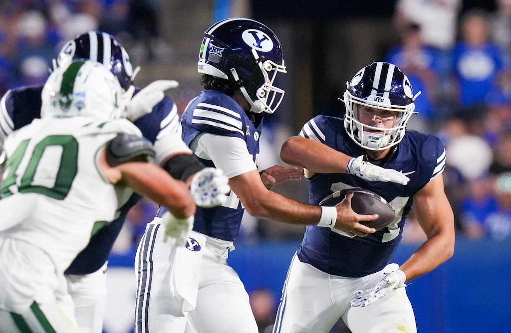 (Bethany Baker | The Salt Lake Tribune) Brigham Young Cougars quarterback Treyson Bourguet (10) hands the ball off to Brigham Young Cougars running back Charles Miska (34) during the game between the Brigham Young Cougars and the Portland State Vikings in Provo on Saturday, Aug. 30, 2025.