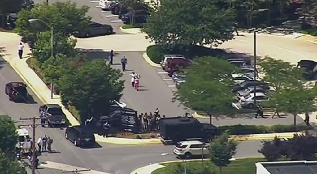 (WJLA | The Associated Press) In this frame from video, people leave the Capital Gazette newspaper after multiple people have been shot on Thursday, June 28, 2018, in Annapolis, Md.