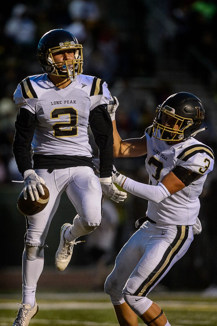 (Trent Nelson | The Salt Lake Tribune) Lone Peak's Brigham Trowbridge celebrates a first half touchdown as Kearns hosts Lone Peak, high school football, Thursday September 14, 2017. At right is Lone Peak's Cody Collins.