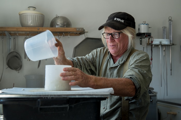 (Leah Hogsten  |  The Salt Lake Tribune) Mesa Farm owner Randy Ramsley separates curds and whey into molds to drain and age into raw tomme or semi-hard alpine cheese. Ramsley sells a variety of goats milk cheeses and yogurt at his farm's storefront on Highway 24, east of Capitol Reef and at Tony Caputo's in Salt Lake City. 