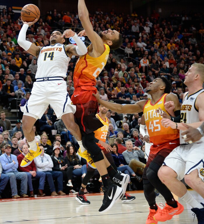 (Francisco Kjolseth  |  The Salt Lake Tribune)  Denver Nuggets guard Gary Harris (14) forces his was past Utah Jazz center Rudy Gobert (27) as the Utah Jazz host the Denver Nuggets in their NBA game at Vivint Smart Home Arena Tuesday, April 9, 2019, in Salt Lake City.