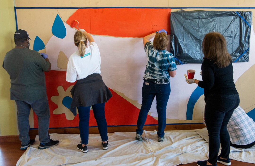 (Rick Egan | The Salt Lake Tribune) ​David Hollins and legislative spouses and partners work on a mural at the  Utah YWCA, during a day of service. According to the media advisory, the project marks the first public-facing event hosted by the First Lady Abby Cox, and involves painting of two pre-traced murals located in common areas utilized by YWCA shelter and housing residents. The murals reflect the YWCA’s mission of eliminating racism and empowering women. Tuesday, March 2, 2021.