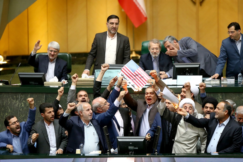 (The Associated Press) Iranian lawmakers burn two pieces of papers representing the U.S. flag and the nuclear deal as they chant slogans against the U.S. at the parliament in Tehran, Iran, Wednesday, May 9, 2018. Iranian lawmakers have set a paper U.S. flag ablaze at parliament after President Donald Trump's nuclear deal pullout, shouting, "Death to America!". President Donald Trump withdrew the U.S. from the deal on Tuesday and restored harsh sanctions against Iran.