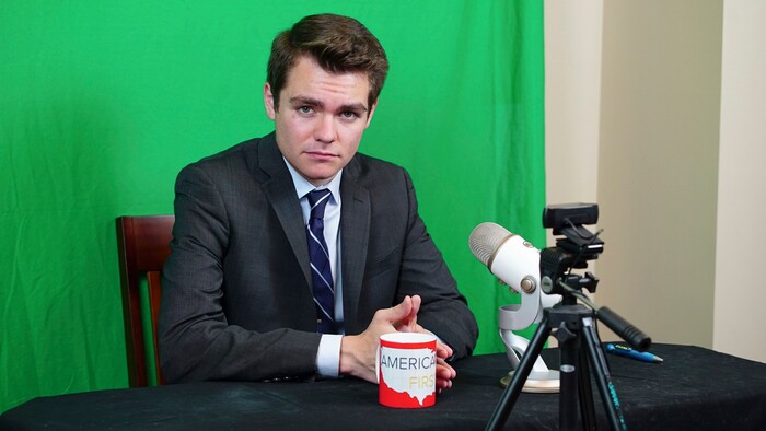 Nicholas Fuentes, poses for a photo in his basement studio in LaGrange Park, Ill., Wednesday, Aug. 16, 2017. The 18-year-old student who attended the white nationalist rally in Virginia last weekend says he has withdrawn from college in Boston in part because of death threats. The studio is where Fuentes records his YouTube show "America First." (AP Photo/Teresa Crawford)