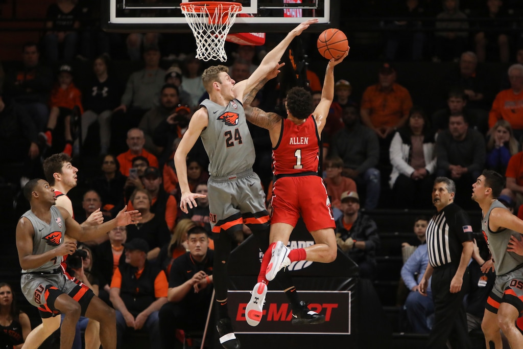 (Amanda Loman | The Associated Press) Oregon State's Kylor Kelley (24) blocks a shot by Utah's Timmy Allen (1) during the first half of an NCAA college basketball game in Corvallis, Ore., Thursday, Feb. 13, 2020.