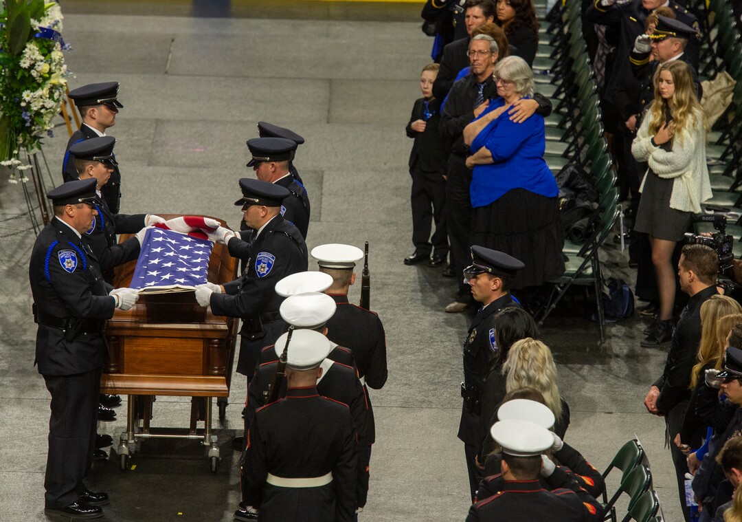 (Rick Egan  |  The Salt Lake Tribune)     The South Salt Lake Police Honor Guard folds the American flag, during the funeral for South Salt Lake police officer, David Romrell, at the Maverik Center in West Valley City, Wednesday, Dec. 5, 2018.