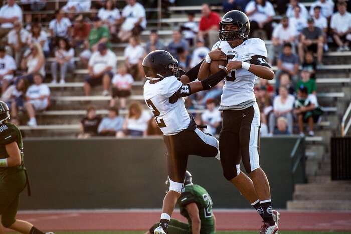 (Chris Detrick  |  The Salt Lake Tribune)    Highland's Richard Tialavea (8) and Highland's Marion Jones (2) celebrate Tialavea's touchdown during the game at Hillcrest High School Friday, September 1, 2017. 