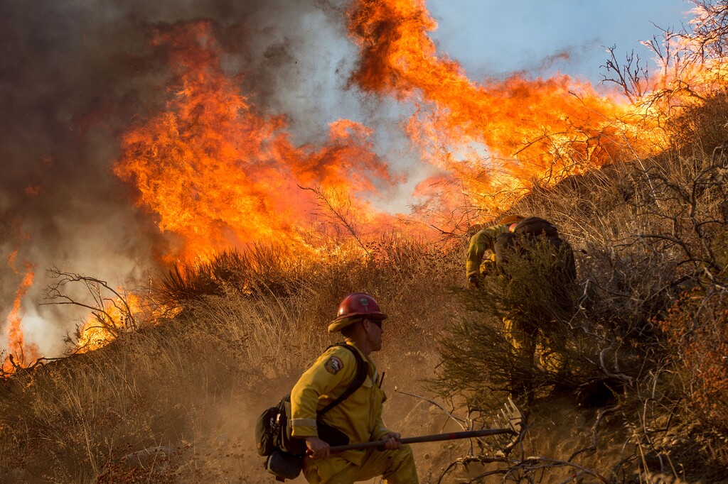 Firefighters battle a wildfire on Cajon Boulevard in Keenbrook, Calif., on Wednesday, Aug. 17, 2016. Firefighters had at least established a foothold of control of the blaze the day after it broke out for unknown reasons in the Cajon Pass near Interstate 15, the vital artery between Los Angeles and Las Vegas. (AP Photo/Noah Berger)