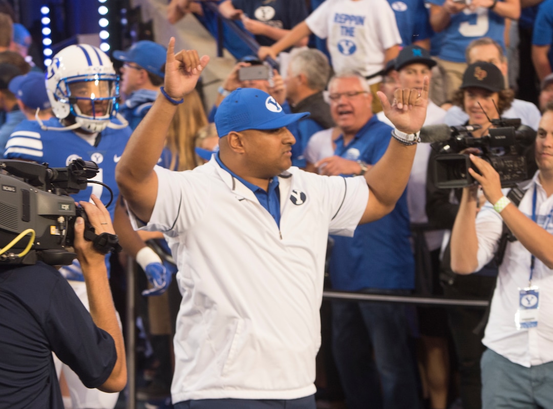 (Rick Egan  |  The Salt Lake Tribune)  Brigham Young Cougars head coach Kalani Satike gets the crowd going as he enters the field before the big game at Lavell Edwards Stadium in Provo, Saturday, September 9, 2017.