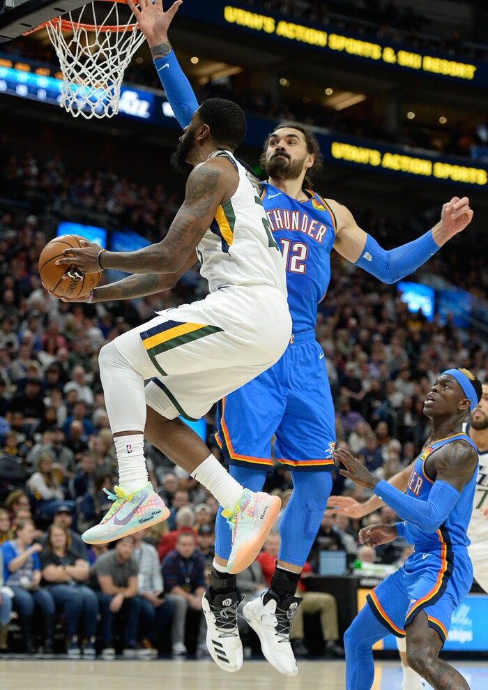 (Francisco Kjolseth  |  The Salt Lake Tribune)  Utah Jazz forward Royce O'Neale (23) is pressured by Oklahoma City Thunder center Steven Adams (12) as the Utah Jazz host the Oklahoma City Thunder in their NBA basketball game at Vivint Smart Home Arena in Salt Lake City on Mon. Dec. 9, 2019.