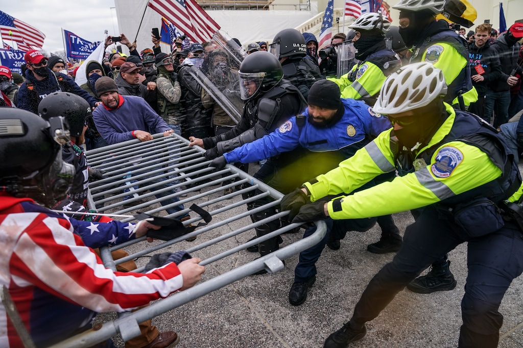 (John Minchillo, AP file photo) In this Jan. 6, 2021, file photo, Trump supporters try to break through a police barrier at the Capitol in Washington. The LDS Church is speaking out against the political violence.