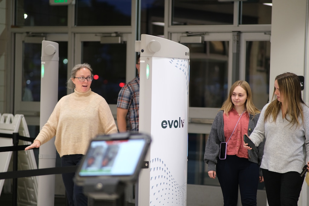 (Michael Lee | Salt Lake Tribune) Parents, students and community members walk through weapons detectors at Highland High School during an open house event to demonstrate the devices on Tuesday, Oct. 10, 2023.