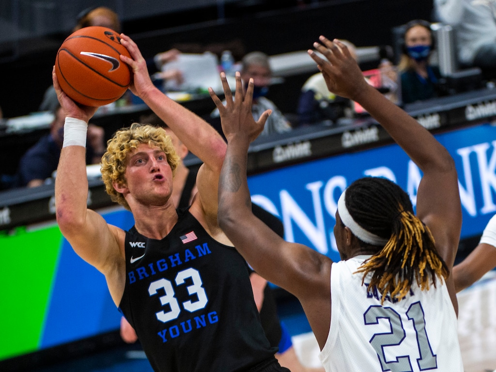(Rick Egan | The Salt Lake Tribune) Brigham Young Cougars forward Caleb Lohner (33) shoots as Weber State Wildcats center Dontay Bassett (21) defends, in basketball action between the Brigham Young Cougars and the Weber State Wildcats at Vivint Arena, on Wednesday, Dec. 23, 2020.