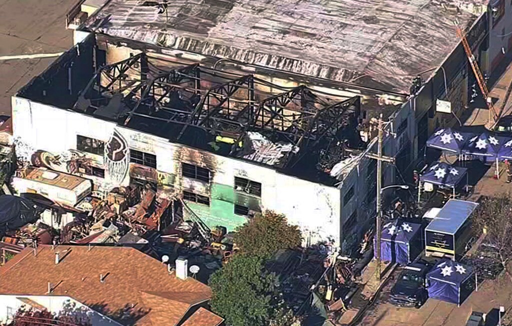 File - In this Dec. 3, 2016 file image from video provided by KGO-TV shows the Ghost Ship Warehouse after a fire swept through the Oakland, Calif., building. A source close to the investigation tells The Associated Press Monday, June 5, 2017, that two men have been arrested and will be charged with involuntary manslaughter in the Ghost Ship warehouse fire that killed 36 partygoers. (KGO-TV via AP, File)