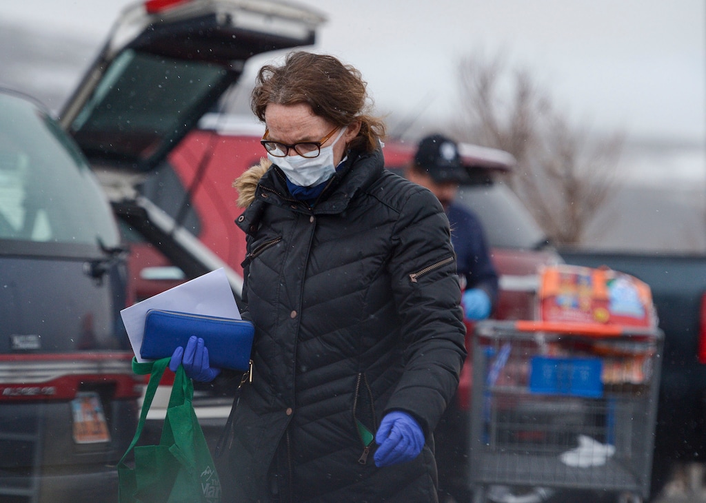 (Leah Hogsten | The Salt Lake Tribune) A woman walks through the parking lot to buy groceries at Walmart in Park City, March 25, 2020. Summit County issued a stay at home order on Wednesday, which goes into effect on Friday and lasts until at least May 1. The order, which is the first of its kind in Utah, asks residents to stop nonessential travel and orders nonessential businesses to close.