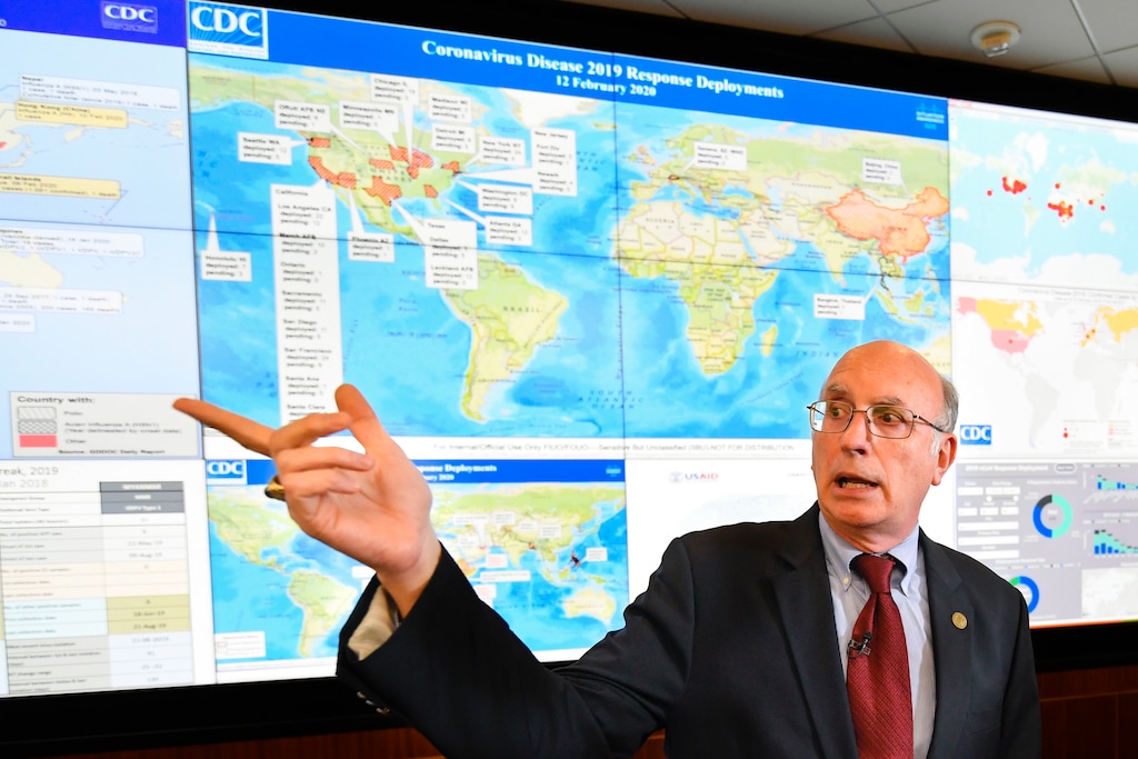 (John Amis | AP) In this Feb. 13, 2020, file photo, Jay Butler, deputy director for infectious diseases at the Centers for Disease Control and Prevention (CDC), speaks to the media in regards to the novel coronavirus, while standing in front of a map marked with areas having reported cases, inside the Emergency Operations Center in Atlanta. In the United States, the nation with the most pandemic deaths, the reporting of vital coronavirus case and testing data is not keeping pace with its speedy spread. Public health officials nationwide lean too heavily on faxes, email and spreadsheets, sluggish and inefficient 20th-century tools.