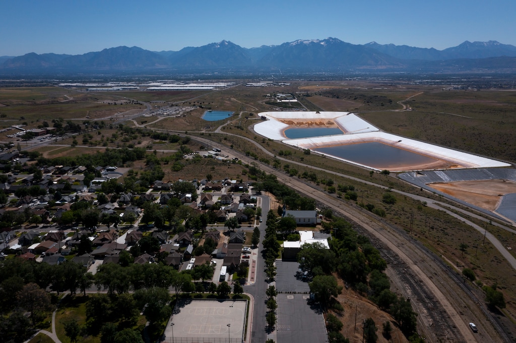(Bethany Baker | The Salt Lake Tribune) Kennecott Utah Copper uses the "Bingham Creek Reservoir," pictured near Copperton on Tuesday, June 18, 2024, to store wastewater from the Bingham Canyon Mine. The staining alone the white walls is from copper residue.