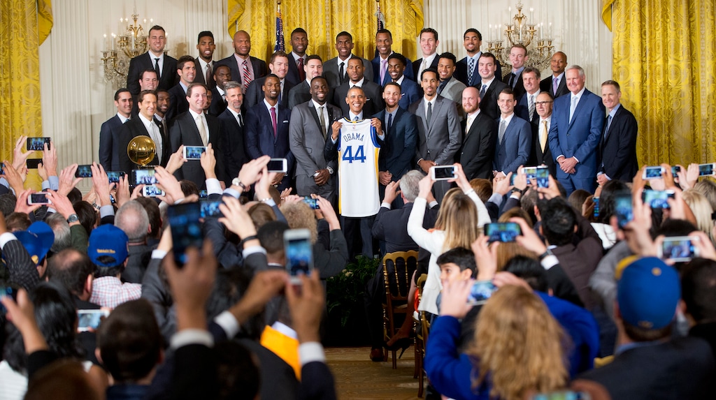 (AP Photo/Pablo Martinez Monsivais, File) In this Feb. 4, 2016, file photo, President Barack Obama holds up Golden State Warrior basketball jersey given to him by team members during a ceremony in the East Room of the White House in Washington where he honored the 2015 NBA Champions. The Warriors had a meeting with former President Obama on Thursday, Jan. 24, 2019, at Obama's office in Washington before the defending NBA champs defeated the Washington Wizards.