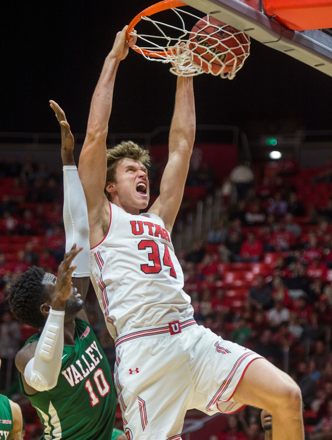 (Rick Egan  |  The Salt Lake Tribune)    Utah Utes center Jayce Johnson (34) dunks the ball, as Mississippi Valley State Delta Devils center Emmanuel Ejeh (10) defends, in basketball action between Utah Utes and Mississippi Valley State Delta Devils at the Jon M. Huntsman Center, Thursday, Nov. 15, 2018.
