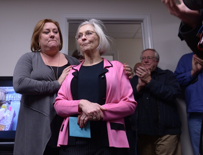 (Leah Hogsten  |  The Salt Lake Tribune) Utah's 3rd Congressional District Democratic candidate Kathie Allen gets a hug from her campaign manager Emily Bingham, left, and applause from her husband, Craig Fineshriber, right, and supporters as she addresses her election staff November 7, 2017 in Holladay after conceding the race to Republican John Curtis.