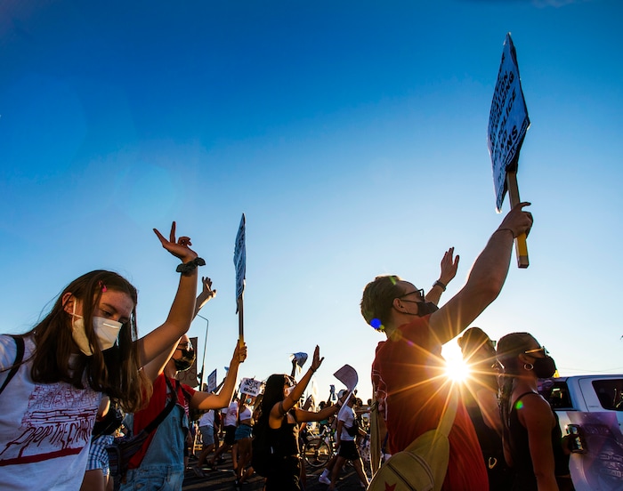 (Rick Egan  |  The Salt Lake Tribune)   Protesters sing along with "We are the World" as they dance  in the streets of Salt Lake City, during the Dance Dance For Revolution protest for racial equality, on Sunday, Aug. 9, 2020.