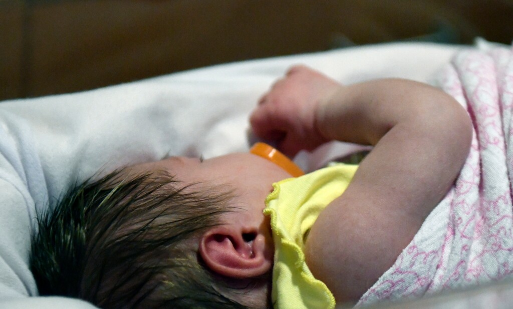 A week old baby lies in one of the ICU bays at one of the Norton Children's Hospital neonatal intensive care units Tuesday, Feb. 13, 2018, in Louisville, Ky. This particular NICU, is dedicated to newborns of opioid addicted mothers, that are suffering with newborn abstinence syndrome, is kept dark and quiet due to increased production of neurotransmitters in newborns of addicted mothers, which can disrupt the nervous system and overstimulate bodily functions. (AP Photo/Timothy D. Easley)