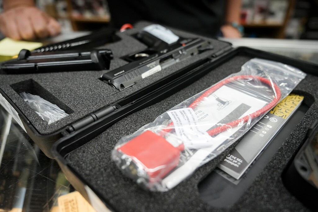 (Bethany Baker  |  The Salt Lake Tribune) A gun lock, provided by the manufacturer as required by Utah and federal law, sits inside the case with a new handgun at the gun shop Gunnies in Orem on Wednesday, Sept. 18, 2024.