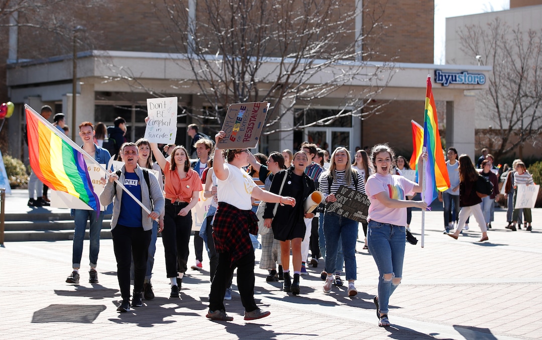 (George Frey  |  special to The Salt Lake Tribune) BYU students and others gather in front of the Ernest L. Wilkinson Student Center on the campus of Brigham Young University to protest BYUÕs rollback of a newly announced policy change on LGBTQ students on March 5, 2020 in Provo, Utah.