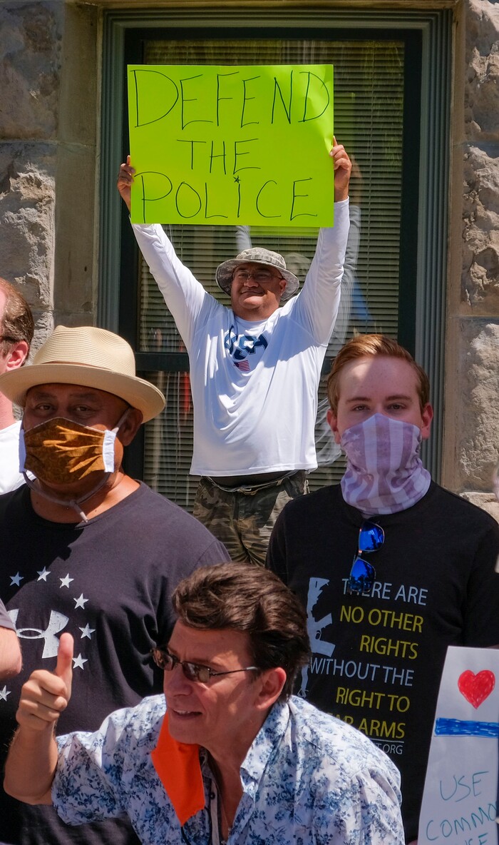 (Leah Hogsten | The Salt Lake Tribune) Joe Asi holding a sign that read "Defend the Police" get his picture taken with fellow supporters of law enforcement gathered at Back the Blue rally, Saturday, August 15, 2020 at Washington Square.