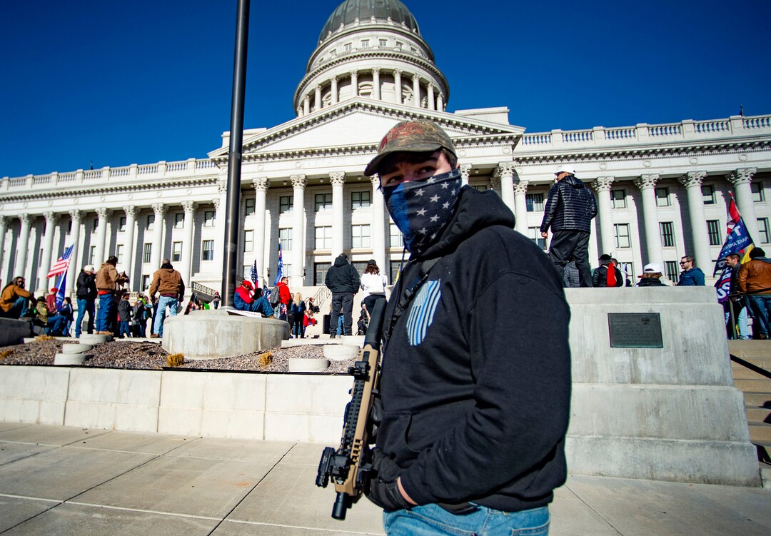 (Rick Egan | The Salt Lake Tribune). A small crowd of Trump protesters gather at the capitol with signs, flags and guns on Wednesday, Jan. 6, 2021.