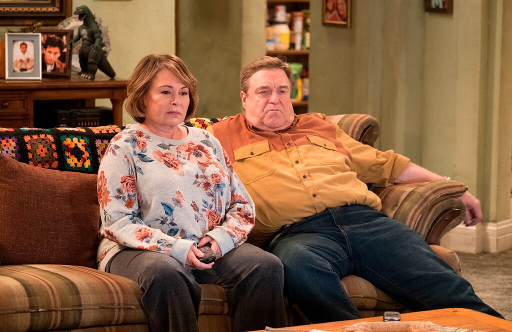 Roseanne Barr and John Goodman appear in a scene from the reboot of "Roseanne." The Nielsen company said viewership for the show's premiere shot up to 25 million people when you count people who watched the three days after last Tuesday's premiere. Never before has a show gained that many viewers via time shifting within three days. (Adam Rose | ABC via The Associated Press)