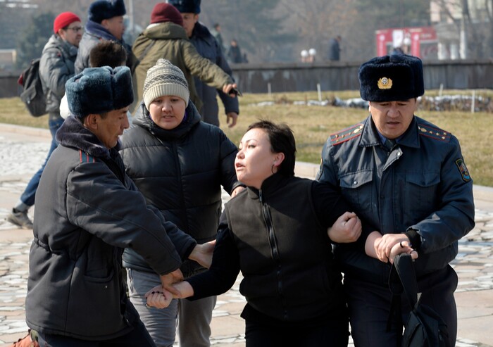 Kyrgyz policemen detain an activist of the Femen women's rights movement at Victory Square during celebration of the International Women's Day in Bishkek, Kyrgyzstan, Sunday, March 8, 2020. (AP Photo/Vladimir Voronin)