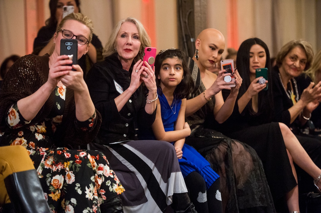 (Rick Egan  |  The Salt Lake Tribune)   Guests watch teh models come down the runway, at the 8th Annual Women of the World Fashion Show. The fashion show fund is raiser for the non-profit that seeks to help refugees settle in a new culture. Wednesday, March 7, 2018.